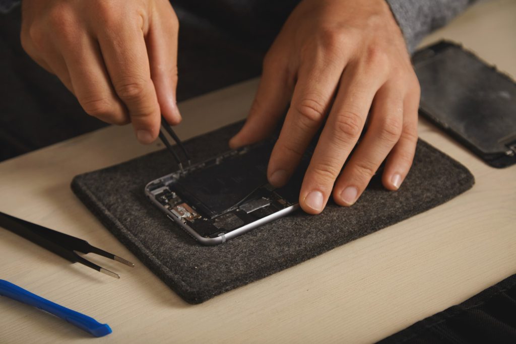 Technician replacing an iPhone screen at FixIt USA in Anderson