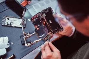 Technician performing smartphone screen repair at FixIt USA